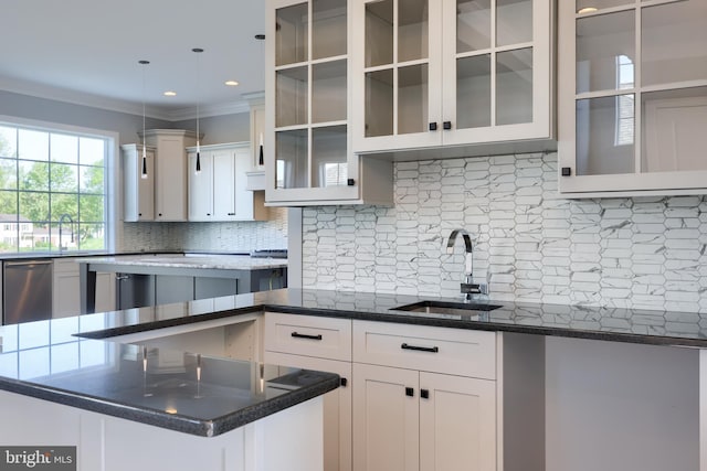 kitchen featuring a sink, white cabinetry, dishwasher, tasteful backsplash, and glass insert cabinets