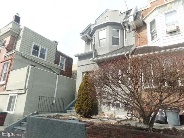 view of side of home with stucco siding