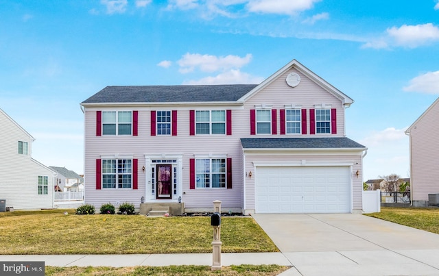 view of front of home with a front yard, central AC unit, fence, driveway, and a garage