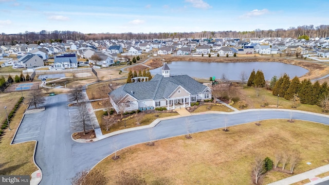 drone / aerial view featuring a water view and a residential view