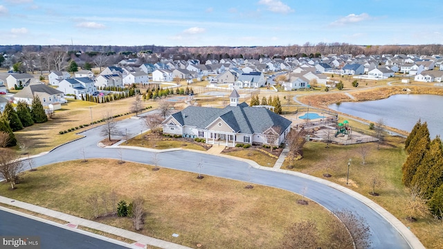 birds eye view of property with a water view and a residential view