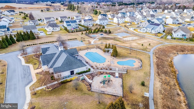 drone / aerial view featuring a water view and a residential view