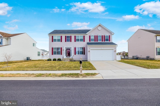 view of front of property featuring driveway, a garage, central AC unit, and a front yard