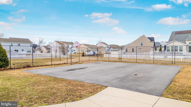 view of sport court with community basketball court, a residential view, fence, and a yard