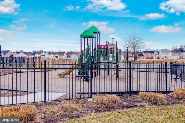 community playground featuring a residential view and fence