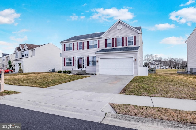 view of front of home featuring concrete driveway, a front lawn, and an attached garage