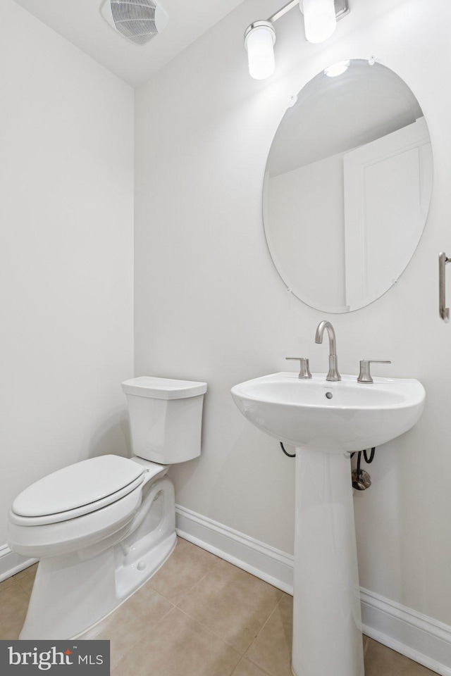 114 Cloak Ln, Lake Frederick, VA 22630 - bathroom featuring toilet, baseboards, tile patterned flooring, and a sink