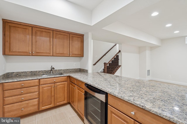 114 Cloak Ln, Lake Frederick, VA 22630 - kitchen with beverage cooler, a sink, light stone counters, brown cabinets, and recessed lighting