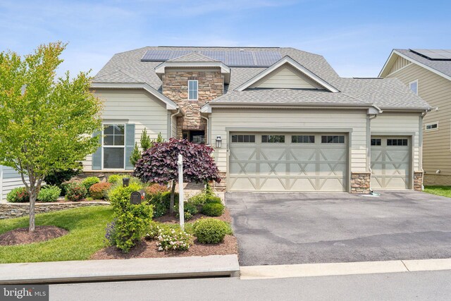 114 Cloak Ln, Lake Frederick, VA 22630 - craftsman-style home featuring stone siding, an attached garage, solar panels, and driveway
