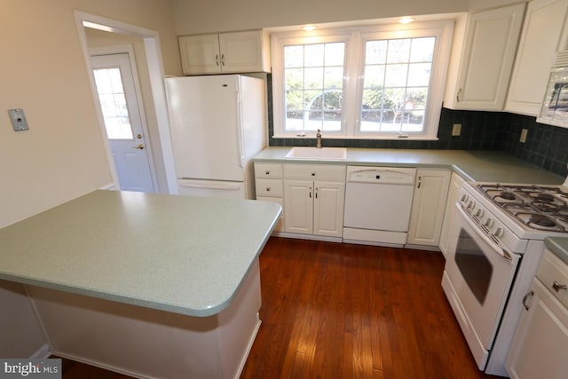 kitchen featuring dark wood finished floors, white appliances, white cabinets, and a sink