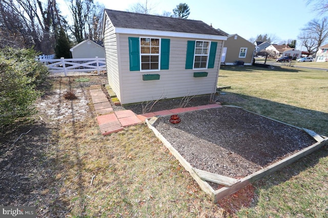 view of outbuilding featuring an outdoor structure and fence