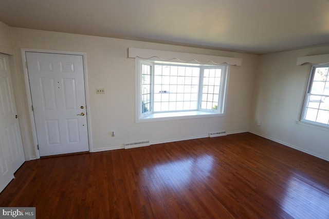 foyer entrance with wood finished floors, visible vents, and baseboards