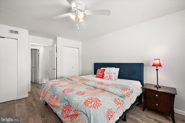 bedroom featuring a ceiling fan, wood finished floors, and visible vents