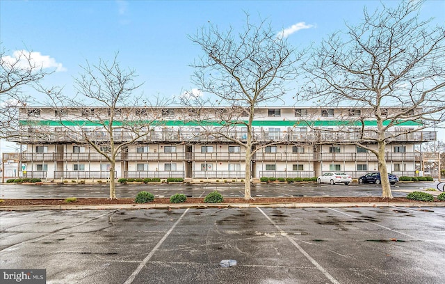 view of building exterior featuring uncovered parking