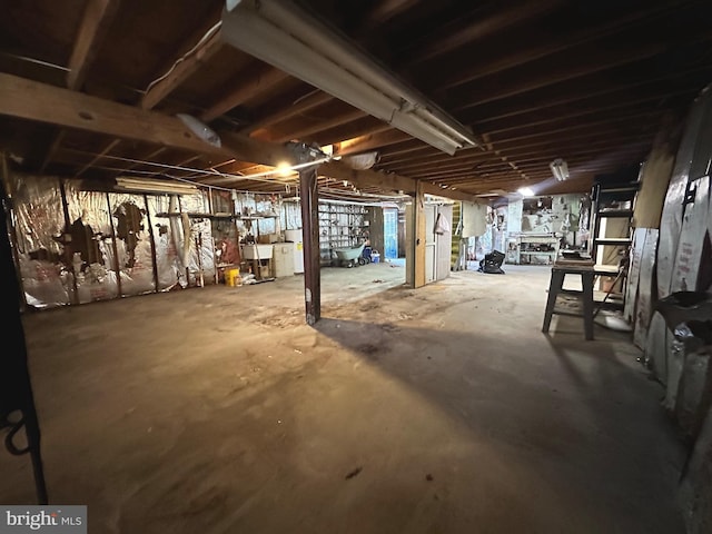 unfinished below grade area featuring washer and clothes dryer and a sink