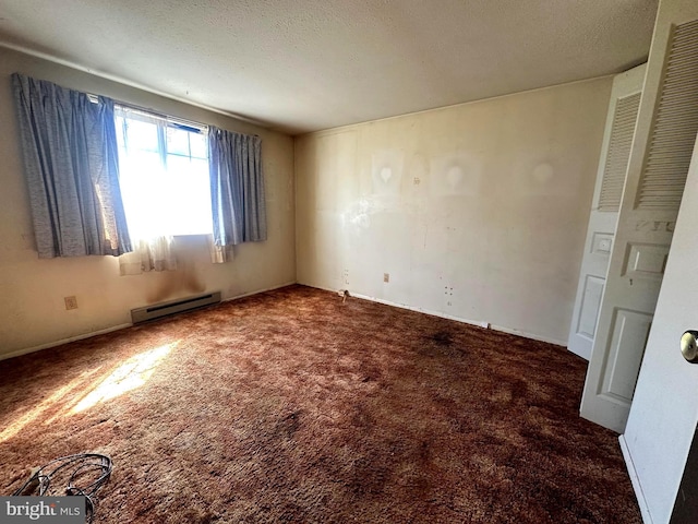 carpeted empty room featuring a textured ceiling and a baseboard radiator