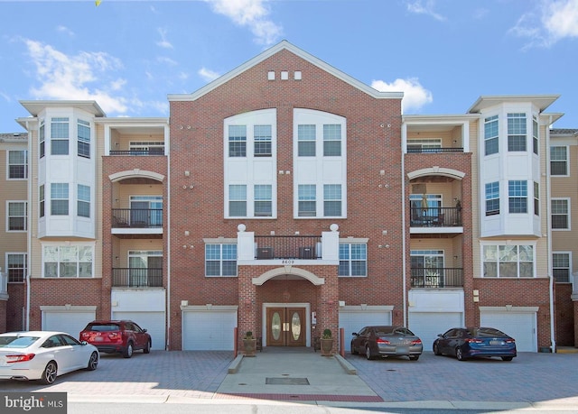 view of building exterior with driveway and a garage