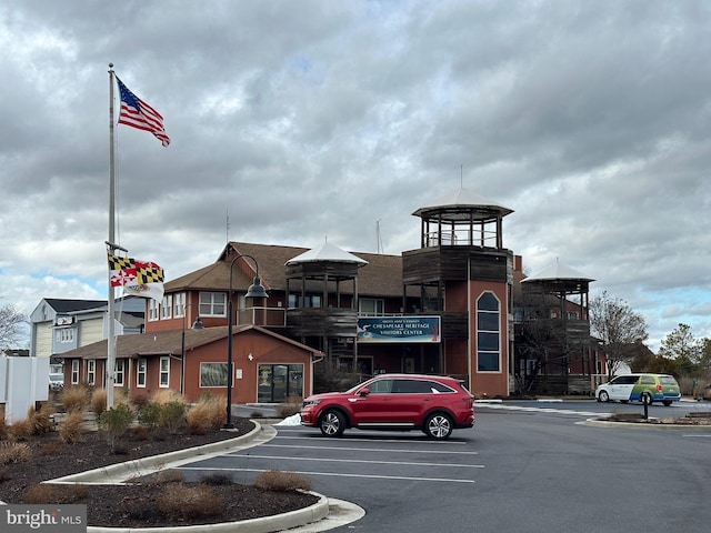 view of building exterior with uncovered parking