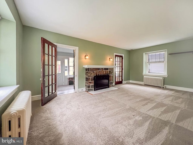 6 Washington Ave, Norristown, PA 19403 - carpeted living area with radiator, plenty of natural light, and a fireplace