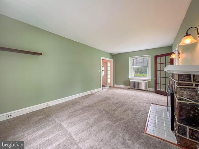 6 Washington Ave, Norristown, PA 19403 - unfurnished living room featuring radiator, carpet flooring, baseboards, and a fireplace