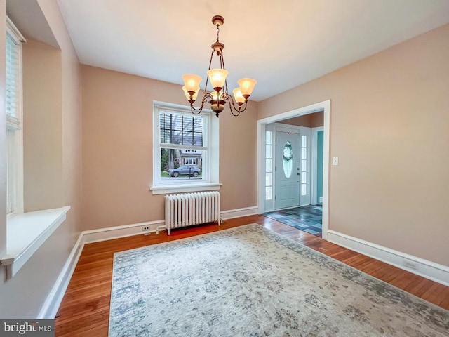 6 Washington Ave, Norristown, PA 19403 - unfurnished dining area featuring radiator, a chandelier, wood finished floors, and baseboards