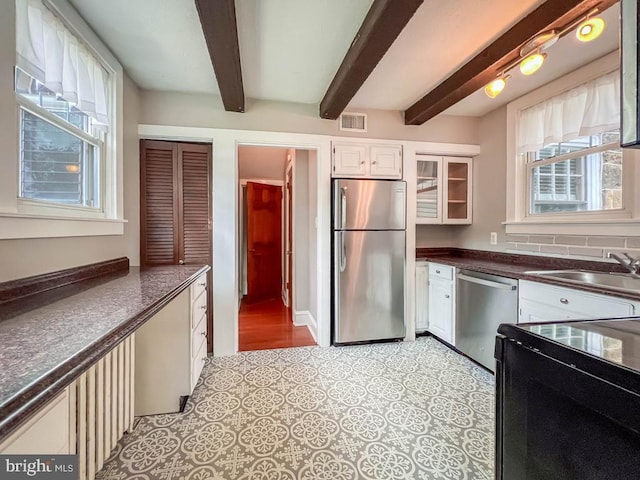 6 Washington Ave, Norristown, PA 19403 - kitchen featuring stainless steel appliances, a sink, beam ceiling, dark countertops, and glass insert cabinets