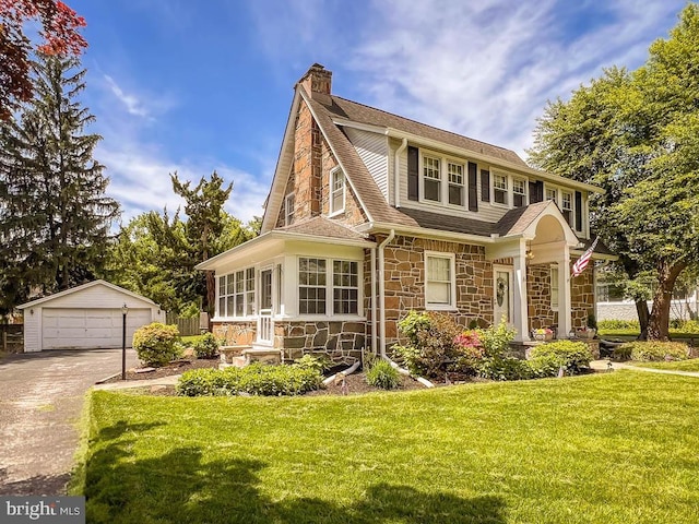 6 Washington Ave, Norristown, PA 19403 - view of front of home featuring stone siding, an outbuilding, a detached garage, a chimney, and roof with shingles