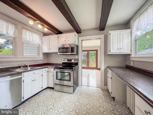 6 Washington Ave, Norristown, PA 19403 - kitchen with appliances with stainless steel finishes, dark countertops, a sink, beam ceiling, and white cabinetry