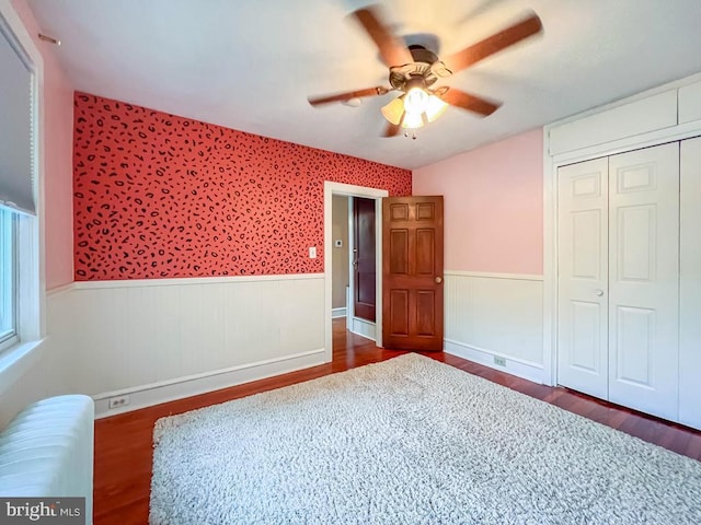6 Washington Ave, Norristown, PA 19403 - unfurnished bedroom featuring wood finished floors, wainscoting, a closet, radiator heating unit, and ceiling fan