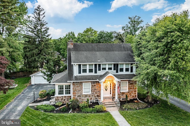 6 Washington Ave, Norristown, PA 19403 - view of front of home featuring an outdoor structure, a garage, a front lawn, a chimney, and stone siding