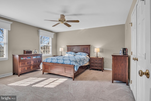 bedroom featuring a ceiling fan, carpet flooring, baseboards, and a closet