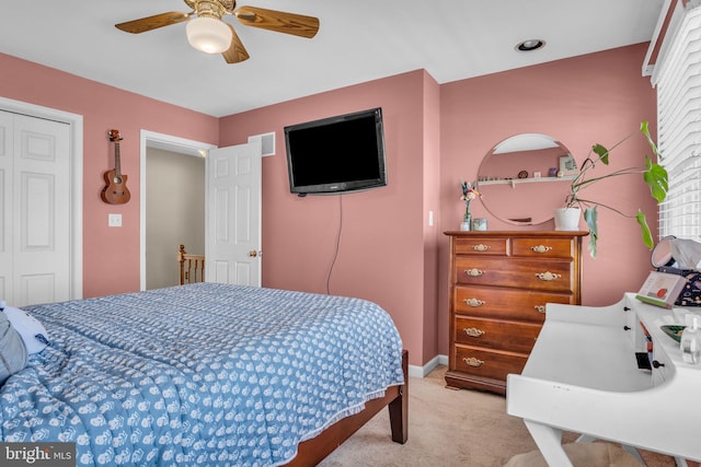 bedroom with visible vents, baseboards, light colored carpet, and ceiling fan