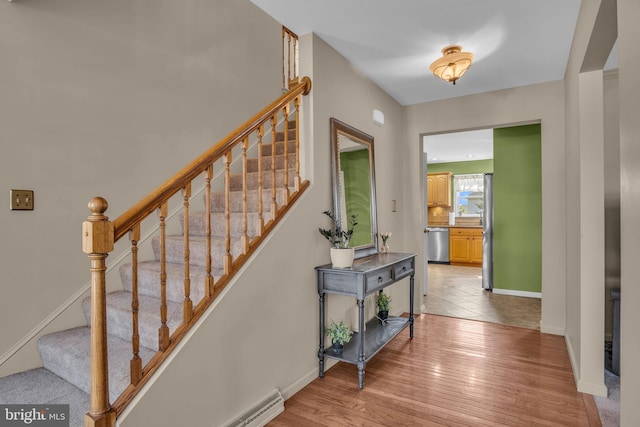 interior space with baseboards and wood finished floors