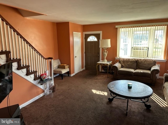 carpeted living area featuring baseboards and stairway