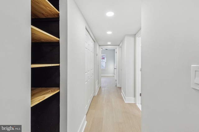 hallway with recessed lighting, baseboards, and light wood-type flooring