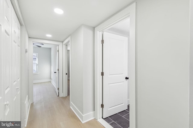 hallway with recessed lighting, baseboards, and light wood-style floors