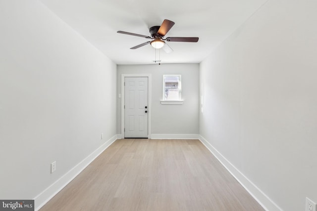 interior space featuring ceiling fan, baseboards, and light wood-type flooring