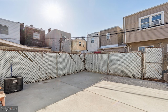 view of patio featuring cooling unit and fence