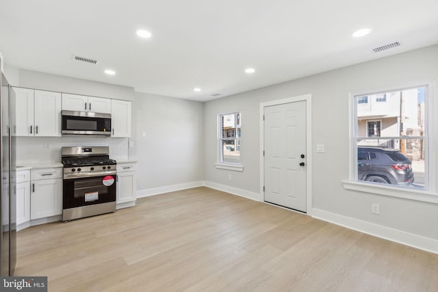 kitchen featuring white cabinetry, visible vents, and appliances with stainless steel finishes