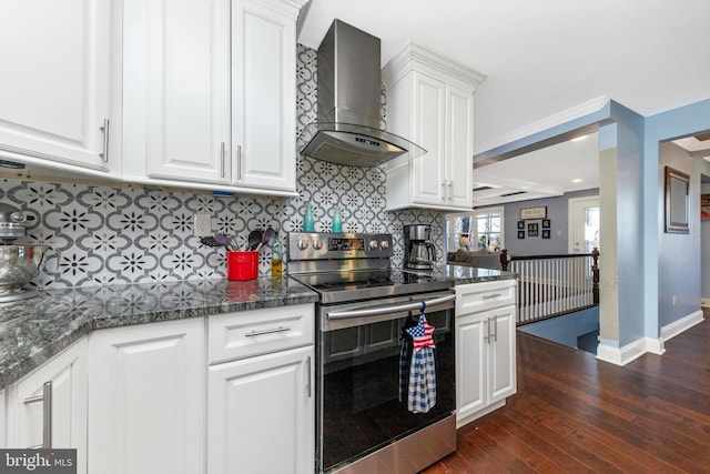 kitchen with dark wood finished floors, stainless steel range with electric stovetop, white cabinets, wall chimney range hood, and backsplash