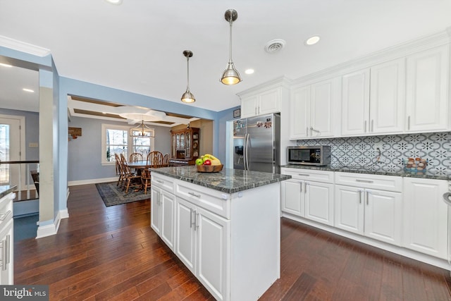 kitchen featuring visible vents, a center island, white cabinetry, stainless steel appliances, and dark wood-style flooring