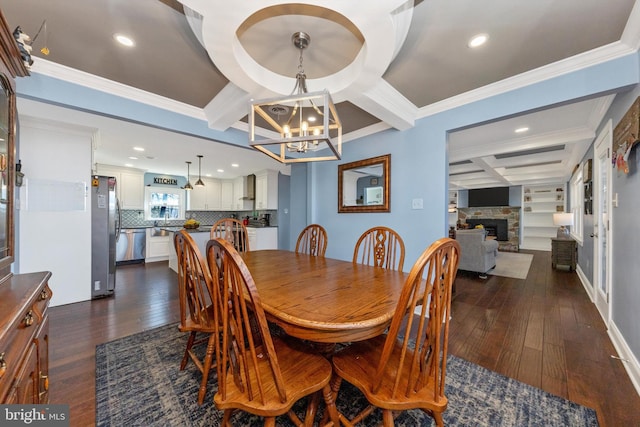 dining area featuring a fireplace, beam ceiling, dark wood-style floors, and coffered ceiling