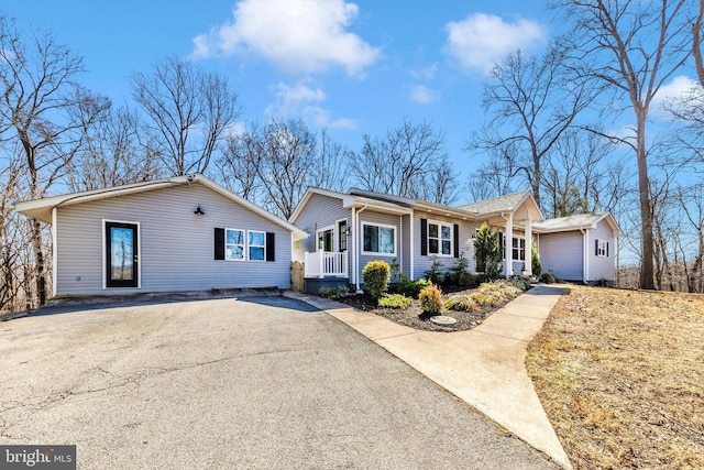 single story home with aphalt driveway