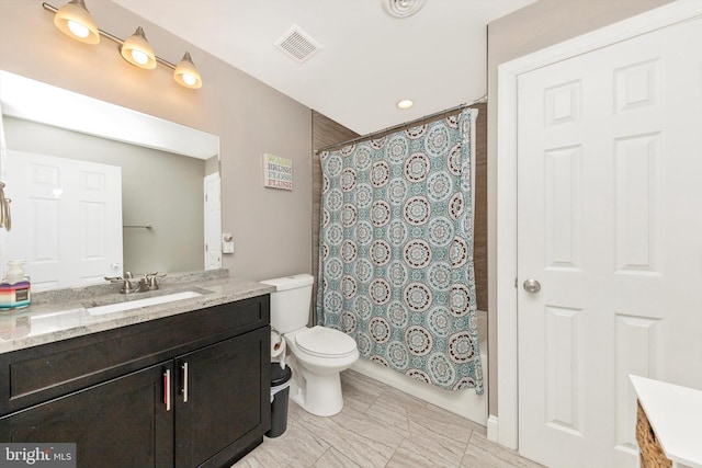 full bathroom featuring vanity, shower / bath combo with shower curtain, toilet, and visible vents