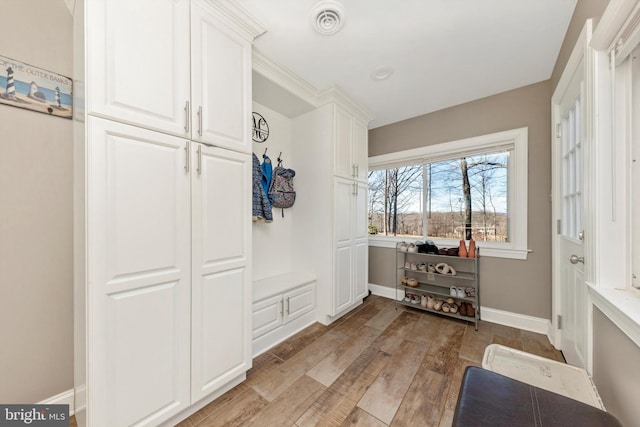 mudroom with visible vents, light wood-style floors, and baseboards