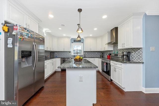 kitchen with stainless steel appliances, wall chimney exhaust hood, dark wood-style flooring, and white cabinetry