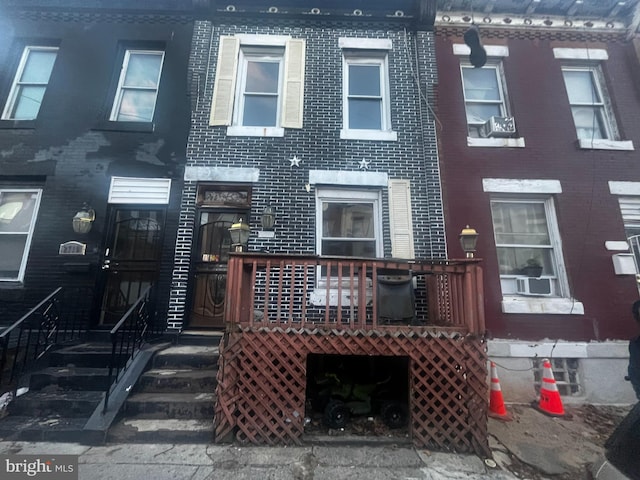 multi unit property featuring cooling unit and brick siding