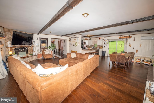 living room featuring hardwood / wood-style floors, beamed ceiling, and a fireplace