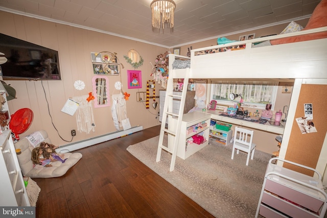 bedroom with a chandelier, baseboard heating, crown molding, and hardwood / wood-style floors