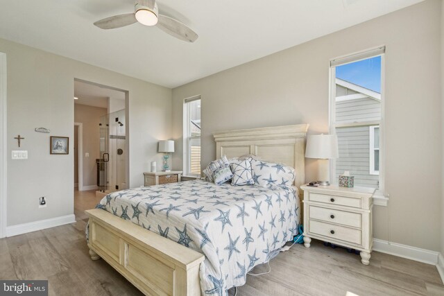 bedroom with baseboards, multiple windows, and light wood-style floors